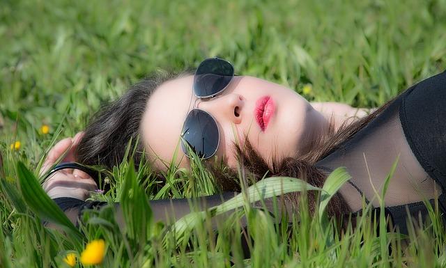 Woman is lying on the grass