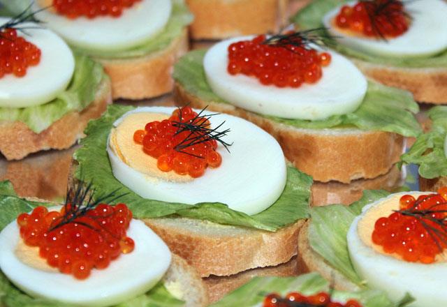 Sandwich with red caviar and boiled chicken egg