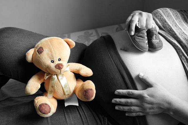 Gravid jente med en bamse